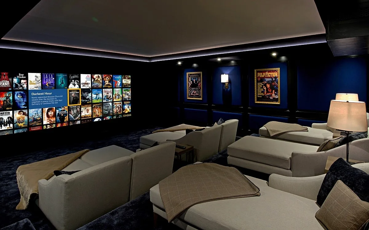 Elegant home cinema with blue walls, recliners, and movie poster art