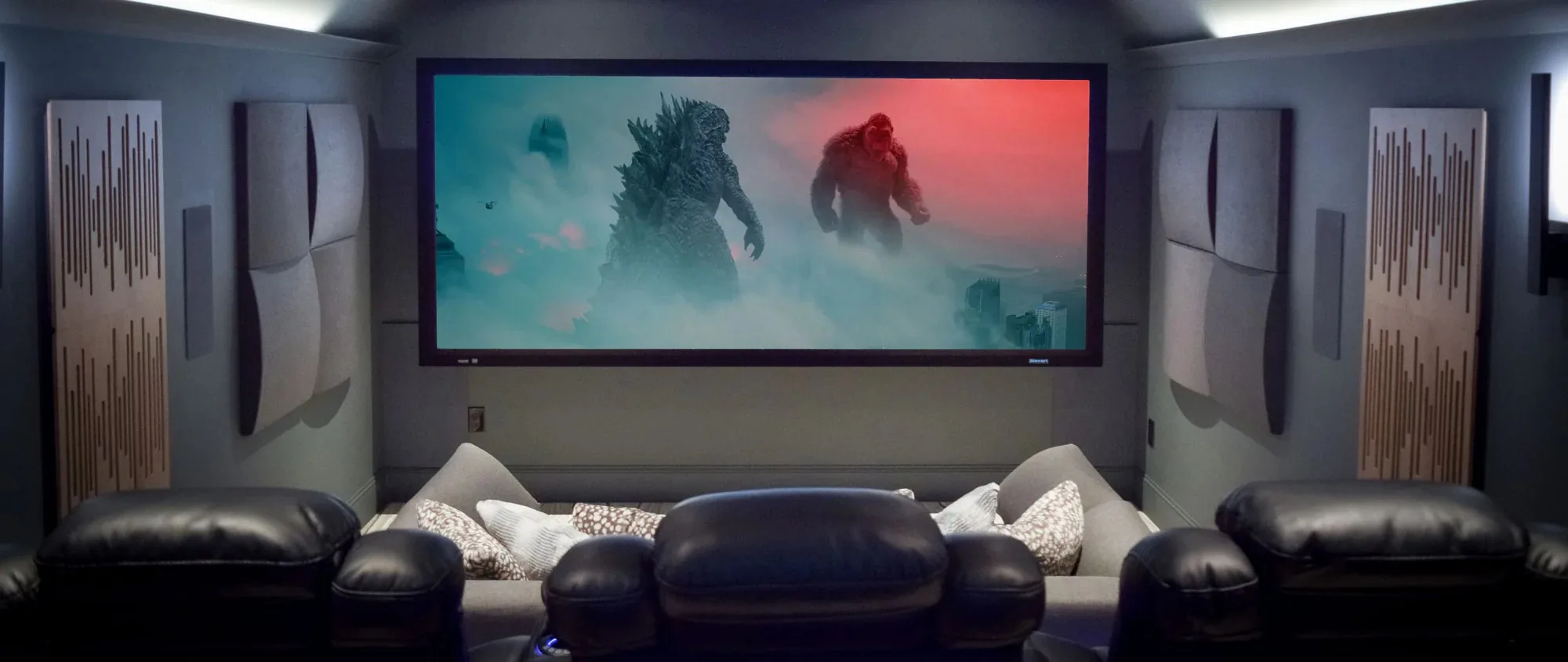 Custom home theater with acoustic panels and large projection screen