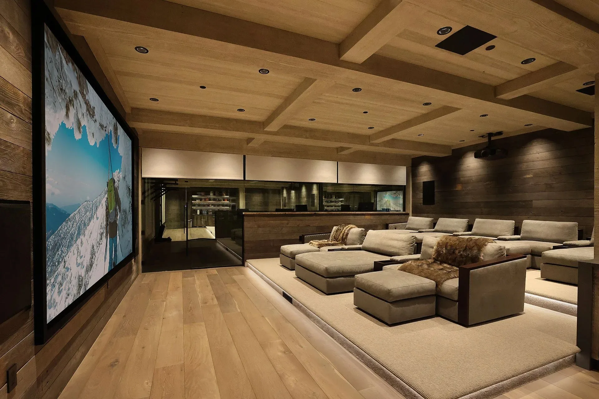 Rustic modern home theater with wood ceiling and large projection screen